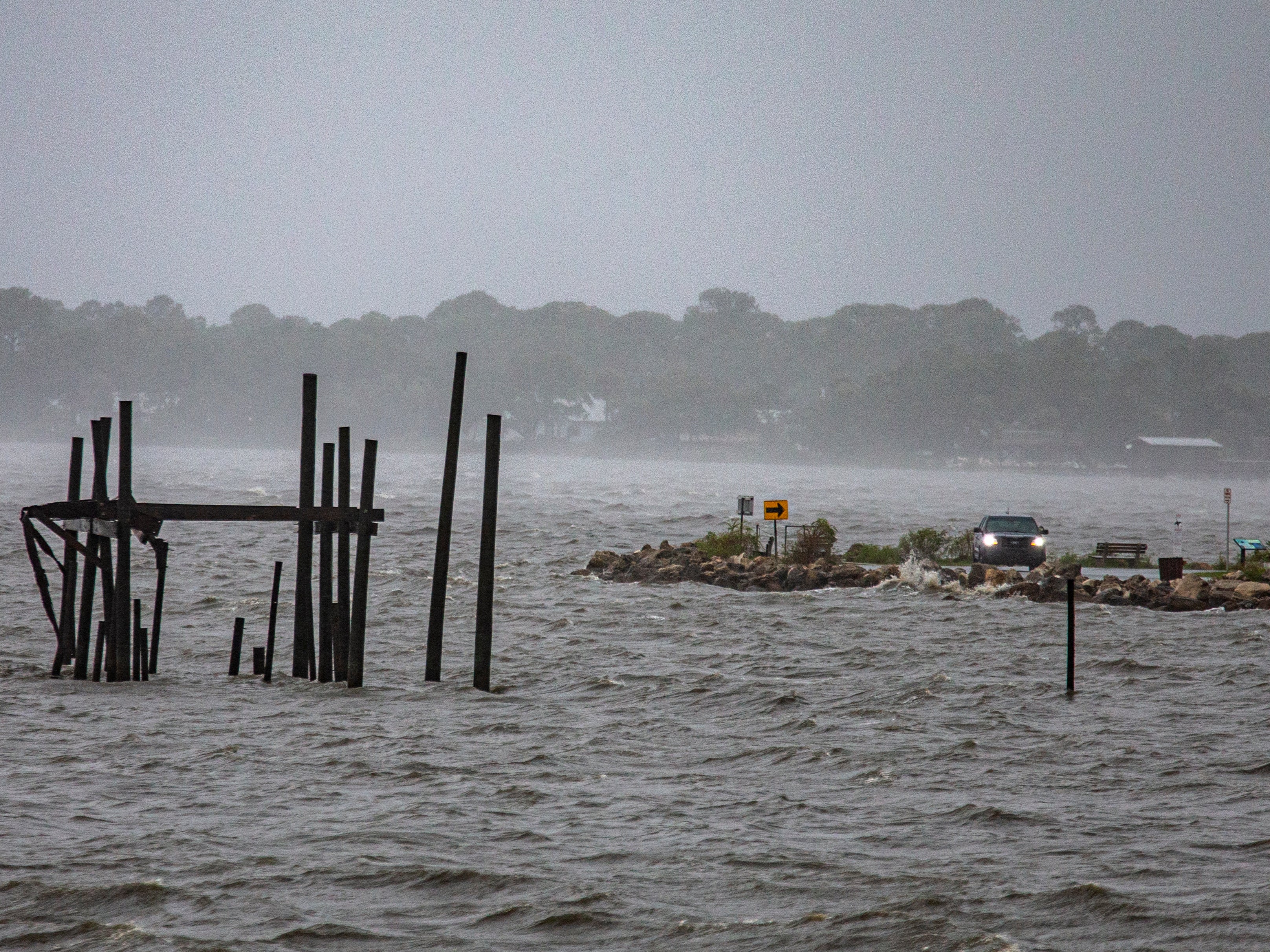 A car drives along the waterfront as Tropical Storm Elsa makes landfall on 7 July 2021 in Cedar Key