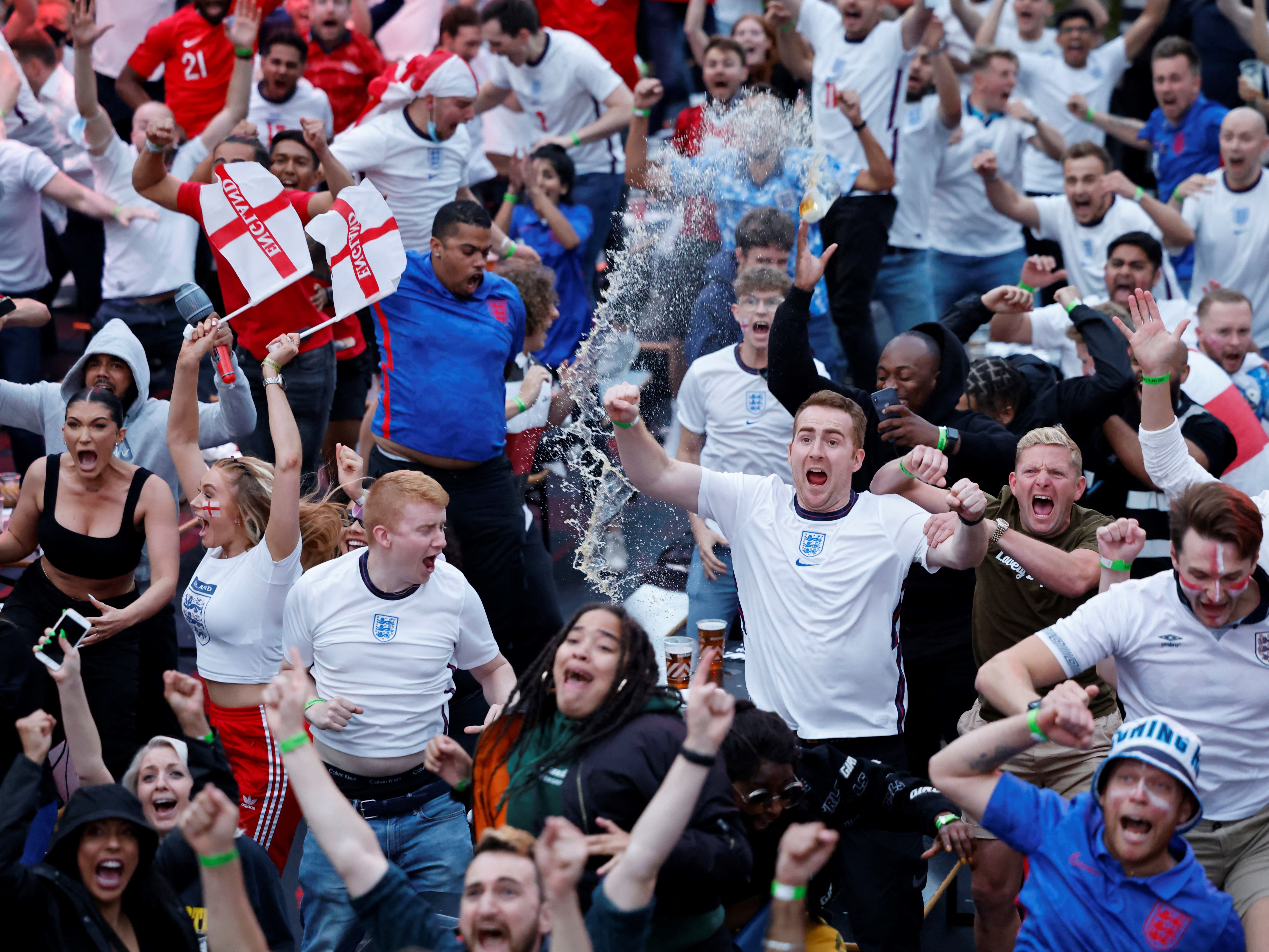 Supporters react to England’s first goal of the night