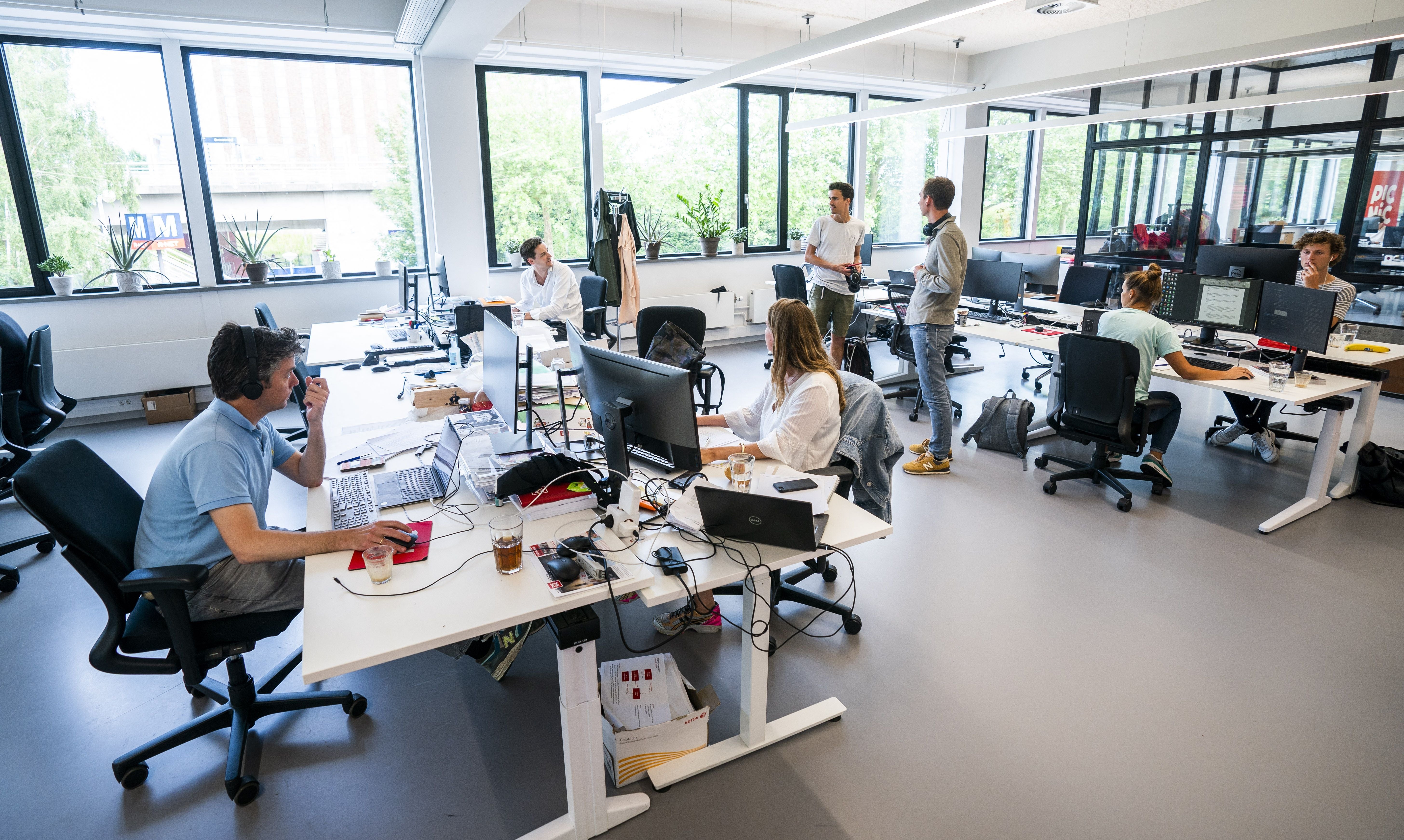 Employees at the online supermarket Picnic are seen at their desks in their office in Duivendrecht, northern Netherlands on 28 June, 2021. A recent suggests burnout is driving workers to look for new opportunities.