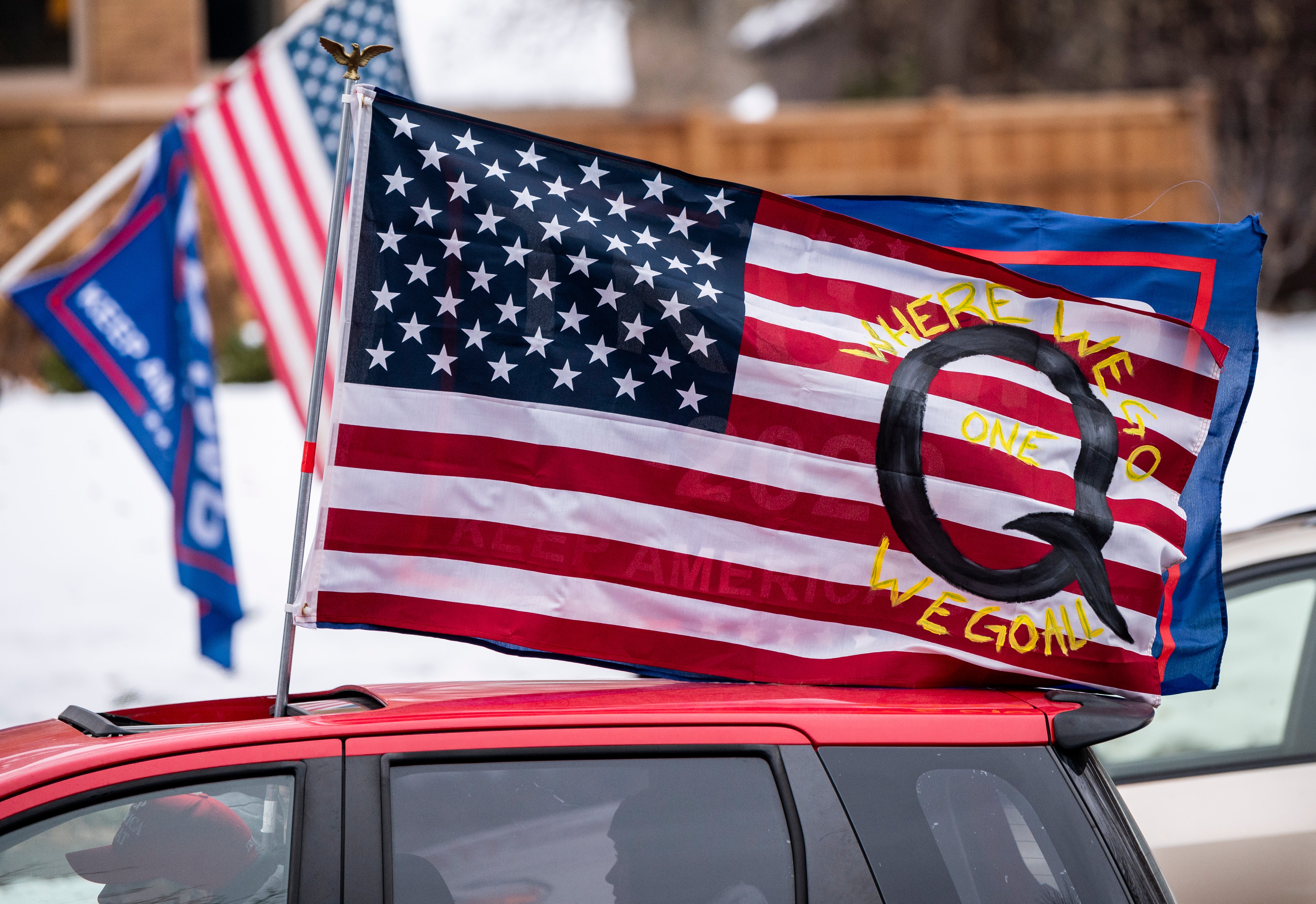 A car with a flag endorsing QAnon drives by outside the Governor's Mansion on 14 November 2020 in St Paul, Minnesota