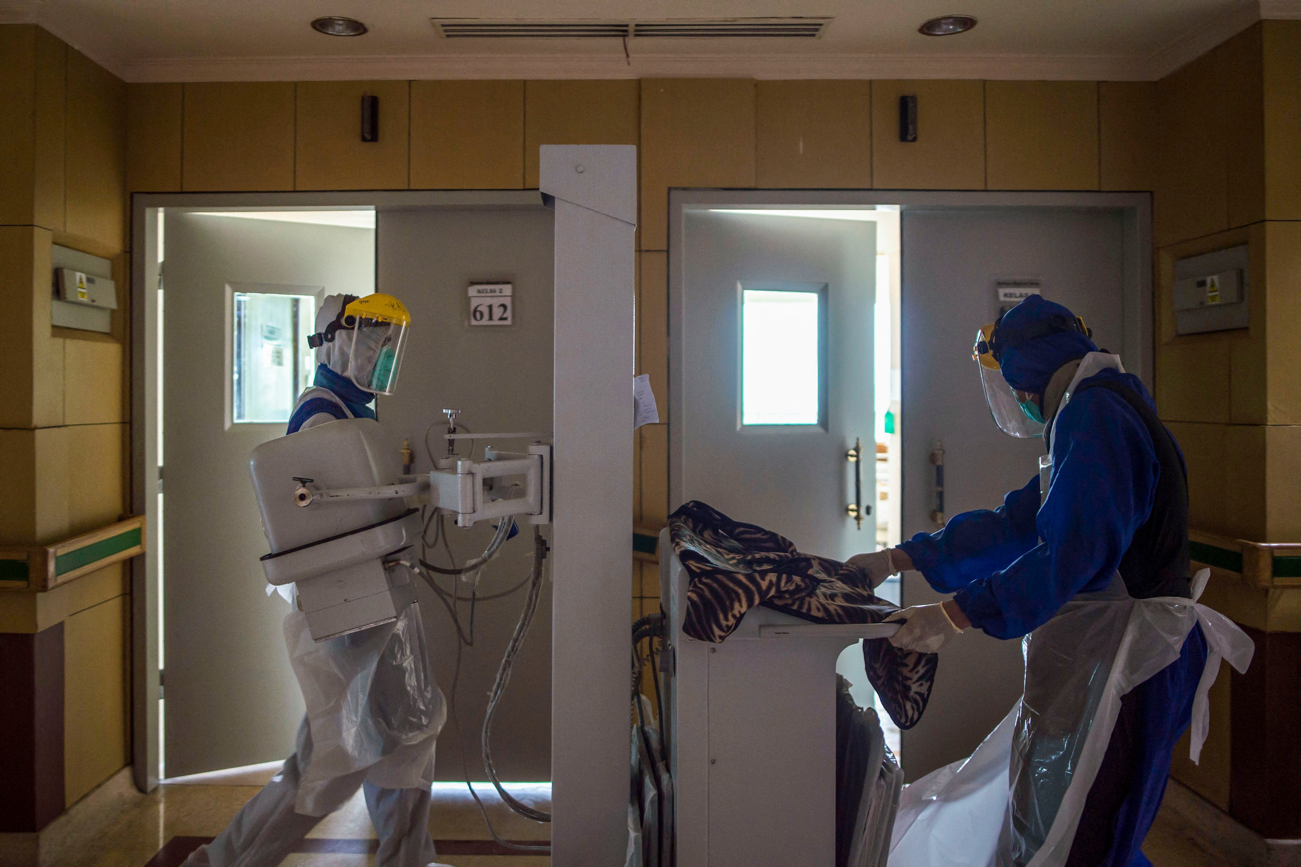 Health workers prepare equipment to treat covid-19 patients at Husada Utama hospital in Surabaya, East Java, on 8 July 2021