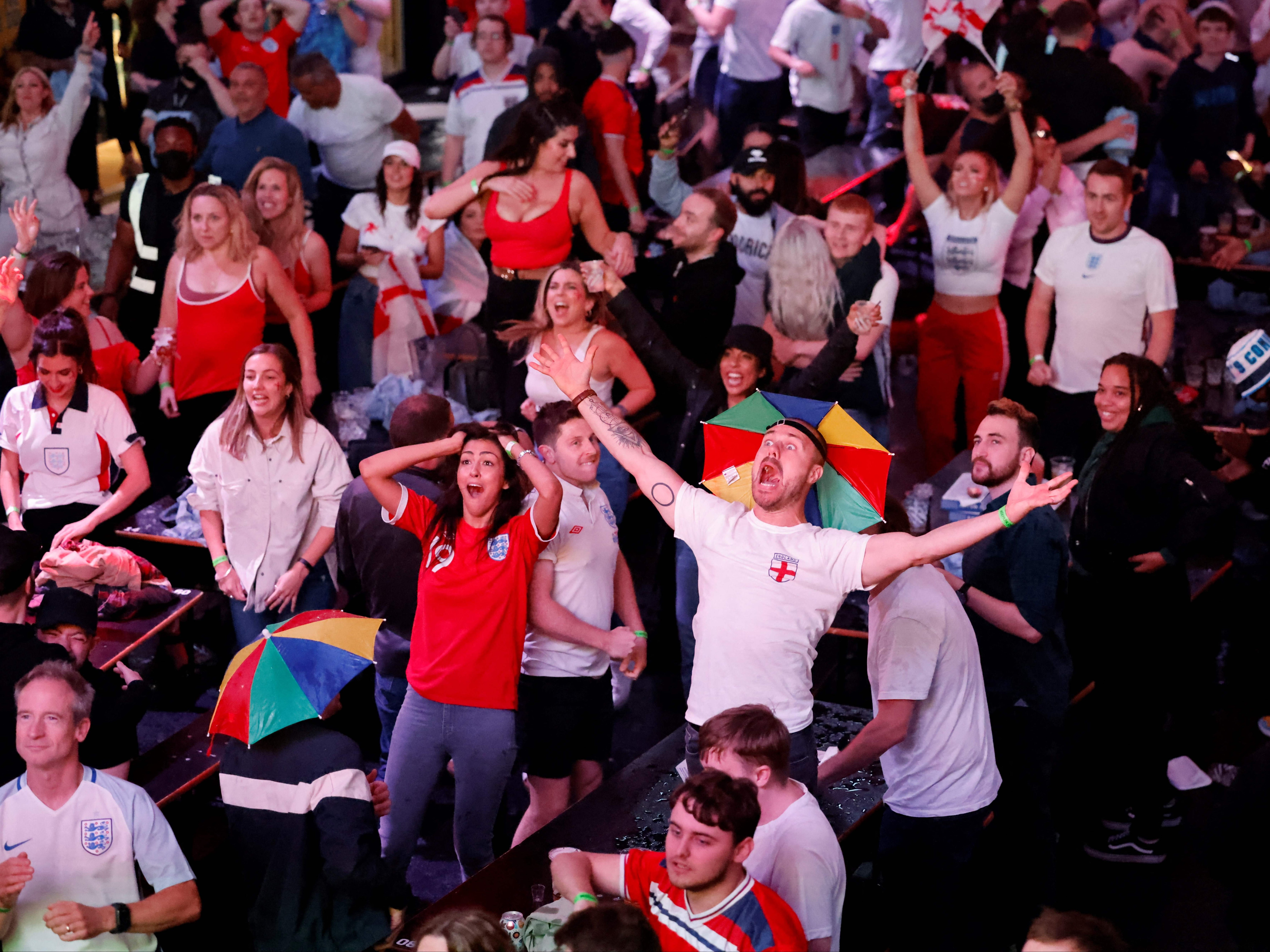 England supporters celebrate England's penalty and second goal as they watch the UEFA EURO 2020 semi-final football match