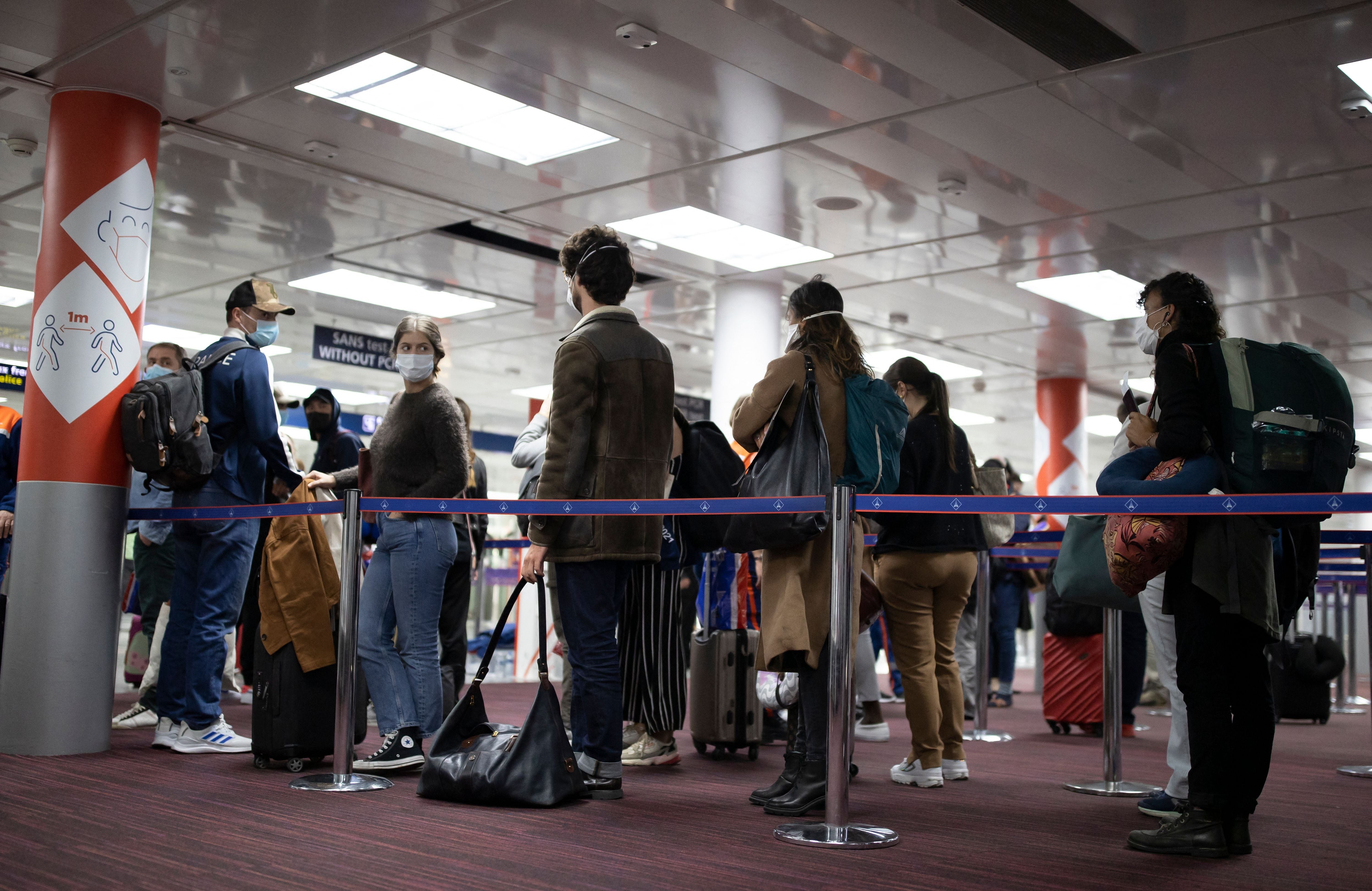 File: Passengers queue up at Roissy Charles de Gaulle airport, near Paris, on 25 April, 2021