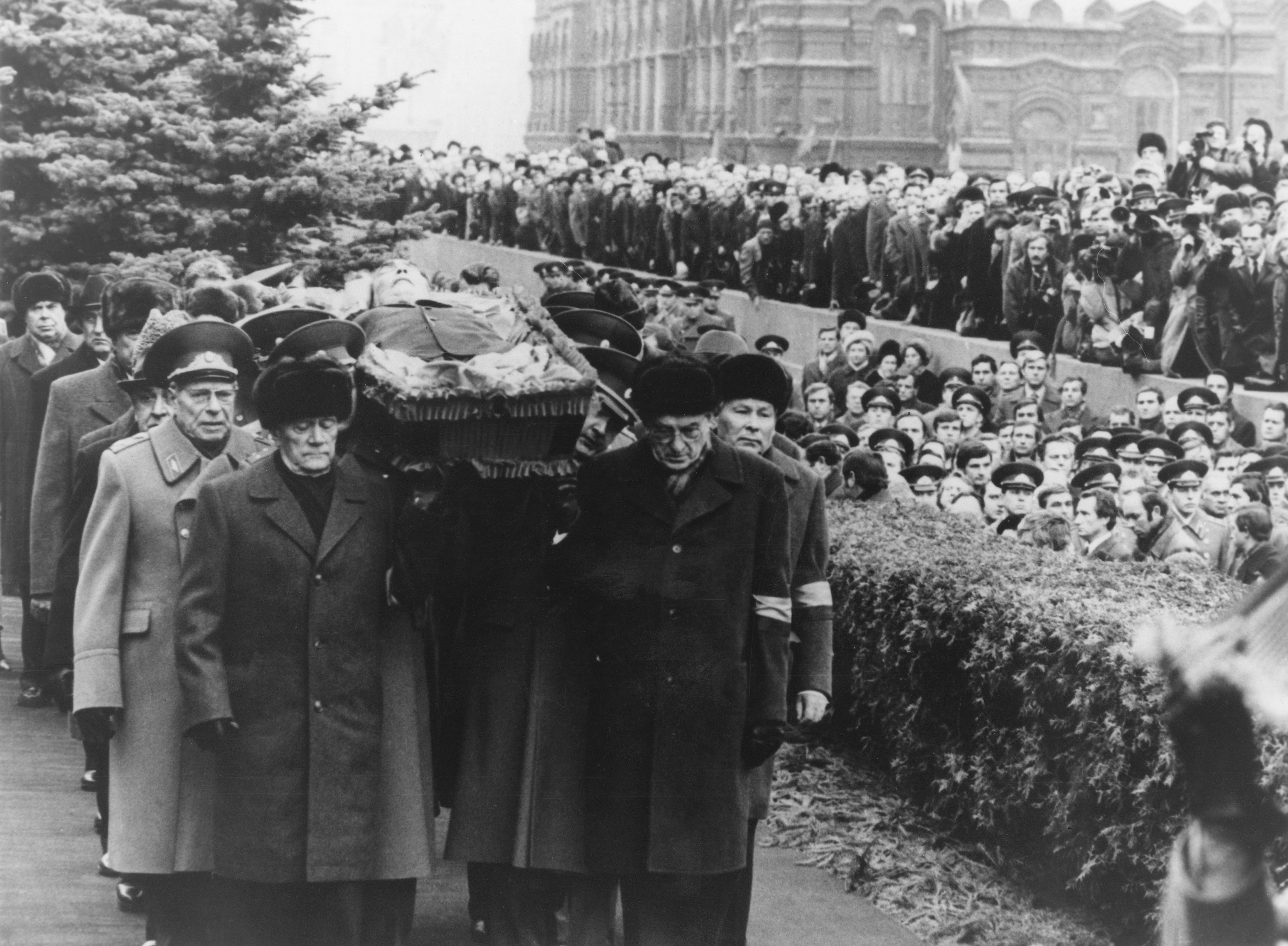 1982: Politburo members carry the open coffin of Leonid Brezhnev to his grave in the Kremlin Wall Necropolis, Red Square