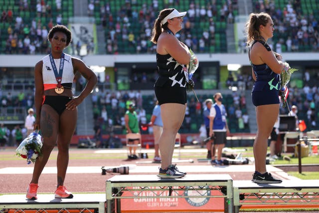 <p>Gwen Berry (L) turns away from US flag during the national anthem on day nine of the 2020 US Olympic Track & Field Team Trials in Eugene, Oregon</p>