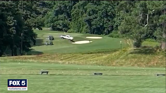 <p>The white pickup truck on the tenth hole at Pinetree Country Club golf course in Georgia, where three bodies were found on 3 July 2021.</p>