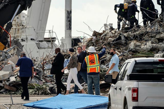 <p>File: In this 5 July 2021 photo, Florida governor Ron DeSantis (centre) tours the site of the rubble in Surfside, Florida</p>