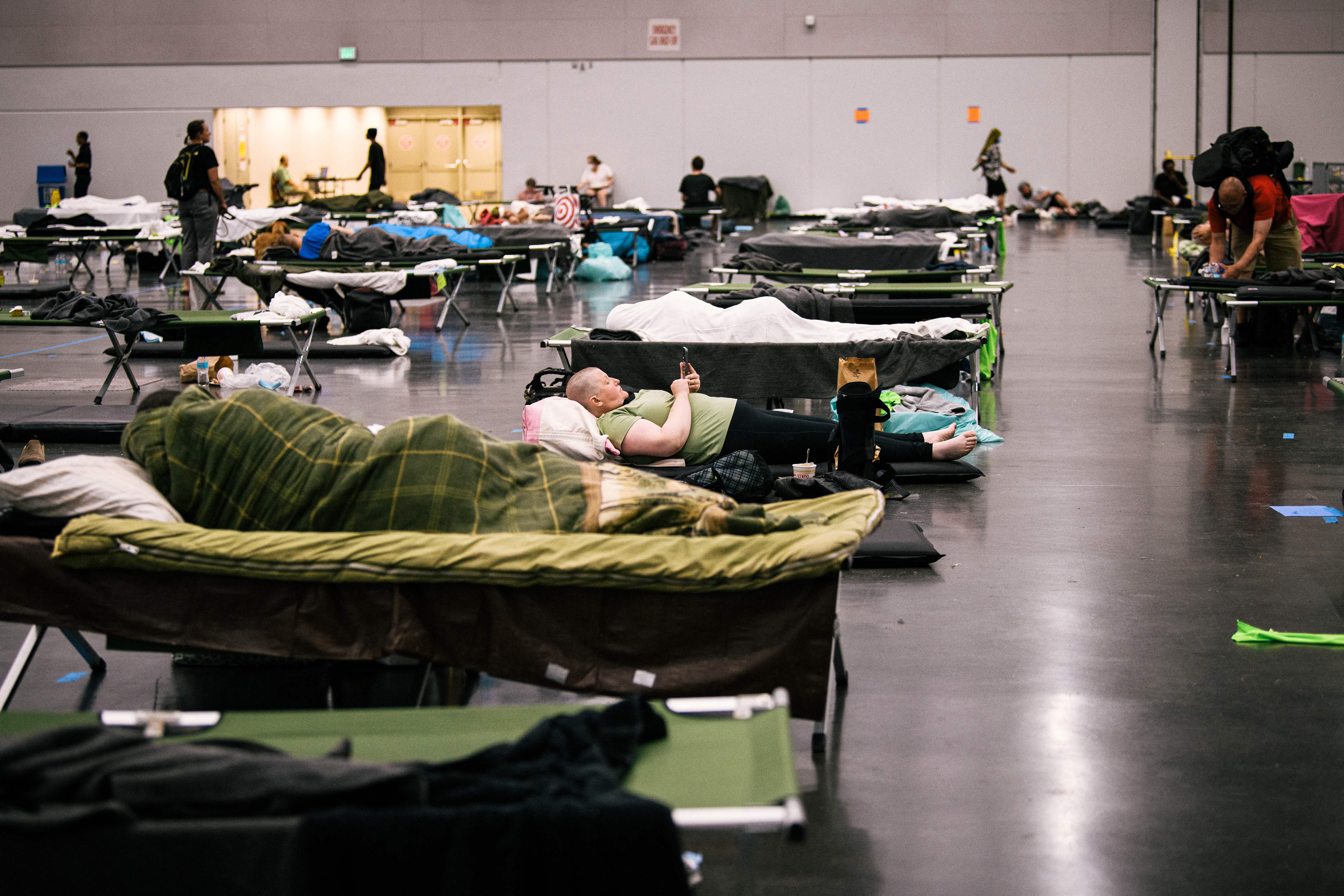 People rest at a convention centre cooling station in Oregon, Portland on 28 June 2021