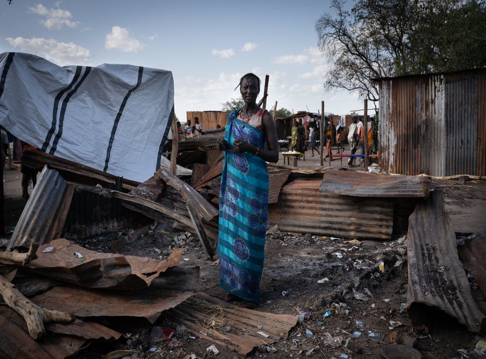 <p>A woman from the Murle ethnic group stands at her destroyed tea shop in Gumuruk, South Sudan, on 10 June, 2021, after her village was attacked by an armed youth group. </p>