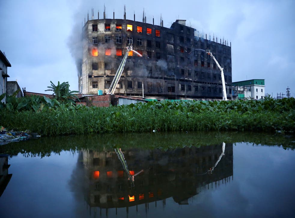 <p>Flames rise the morning after a fire broke out at the Hashem Foods Ltd factory in Rupganj, on the outskirts of Dhaka, Bangladesh</p>