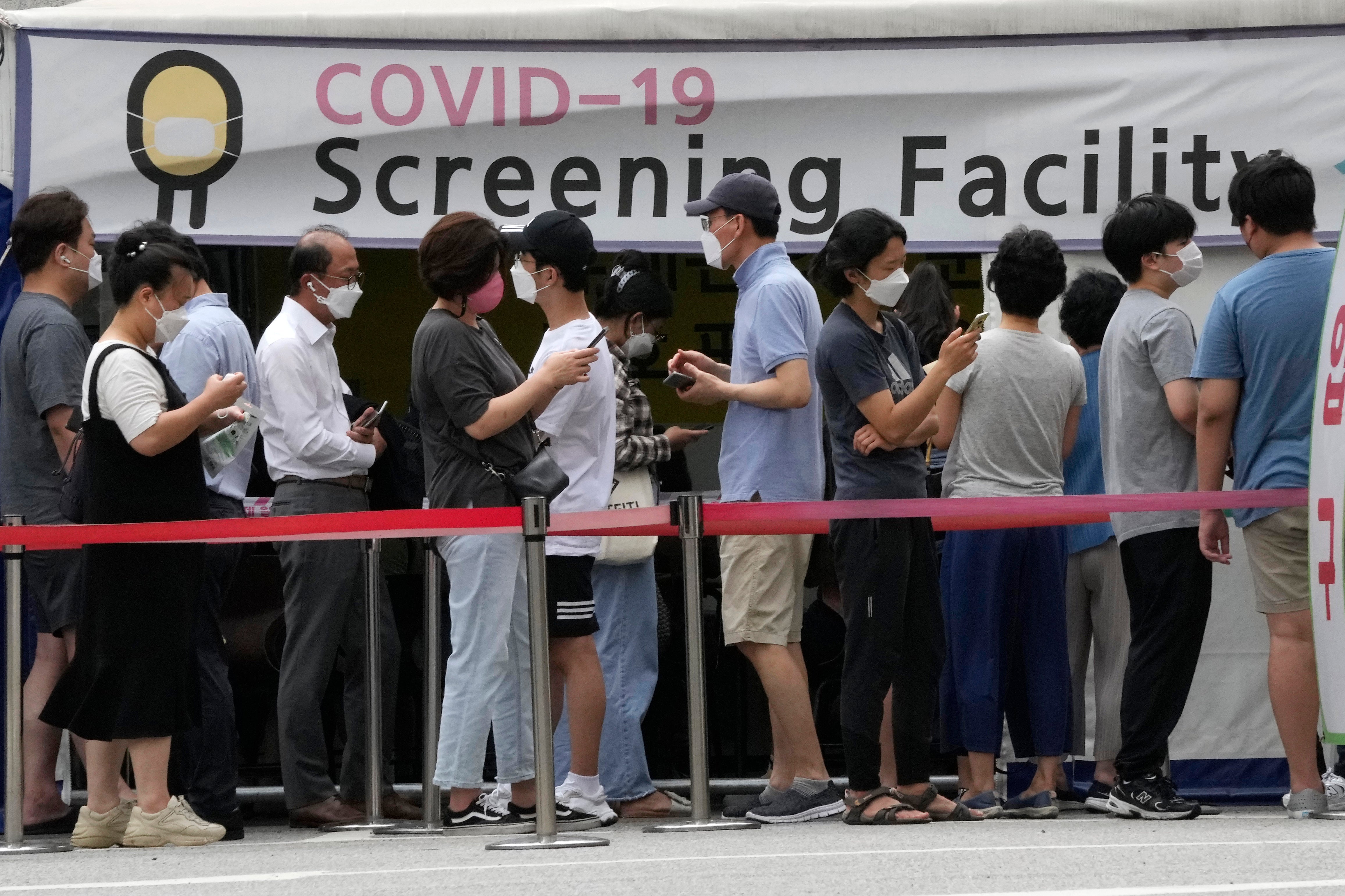 People queue for coronavirus testing at a Public Health Center in Seoul, South Korea on Friday, 9 July, as the country reports its worst wave of infections since the start of the pandemic