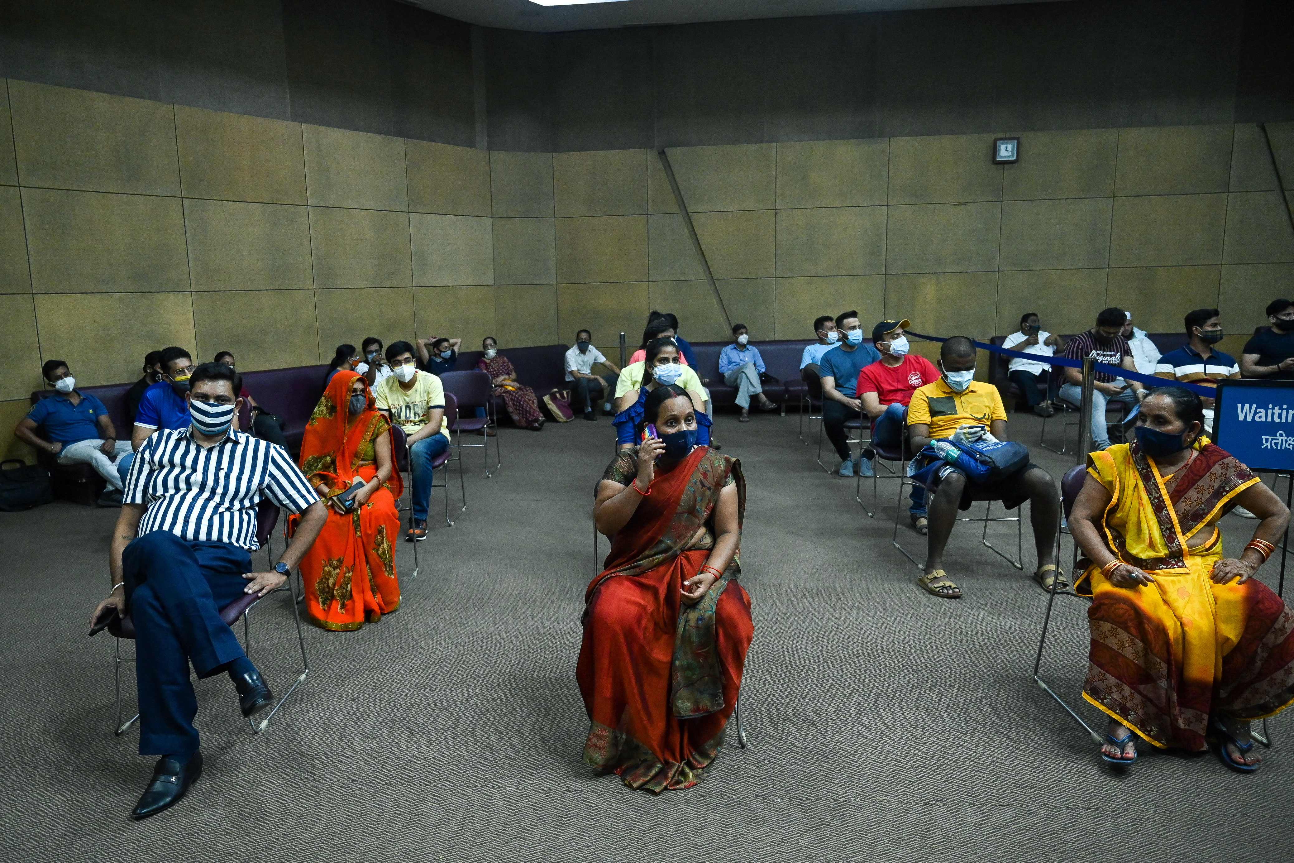 People wait for their turn to be inoculated with a dose of the Sputnik vaccine