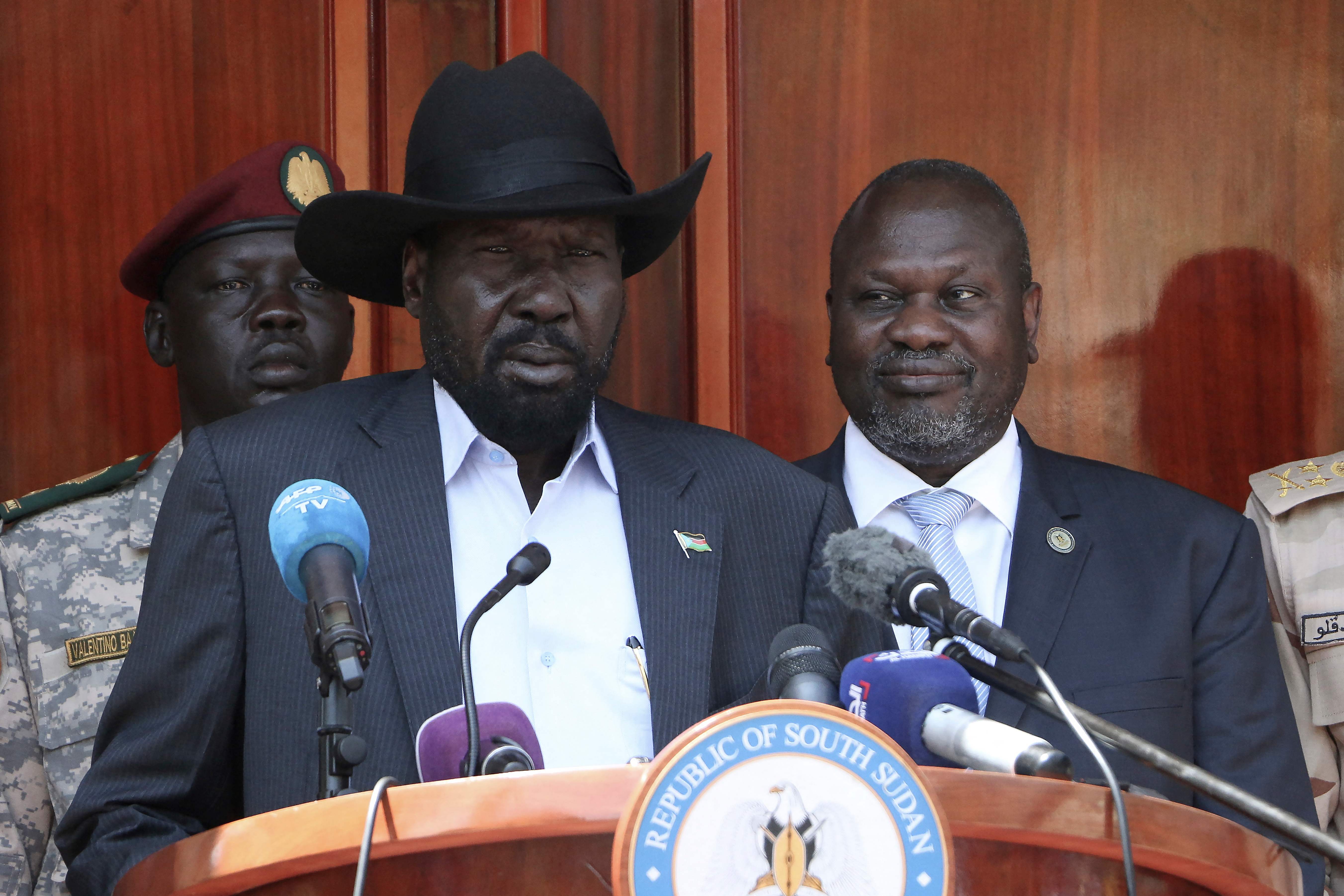 South Sudan President Salva Kiir (C) gives a press conference jointly with his former vice-president and political rival Riek Machar (R) after they met at the State House in Juba, where they confirmed that they had agreed to a joint government in February 2020