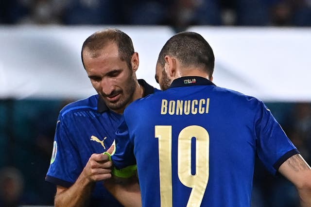 <p>Giorgio Chiellini passes the captain’s armband to Leonardo Bonucci</p>