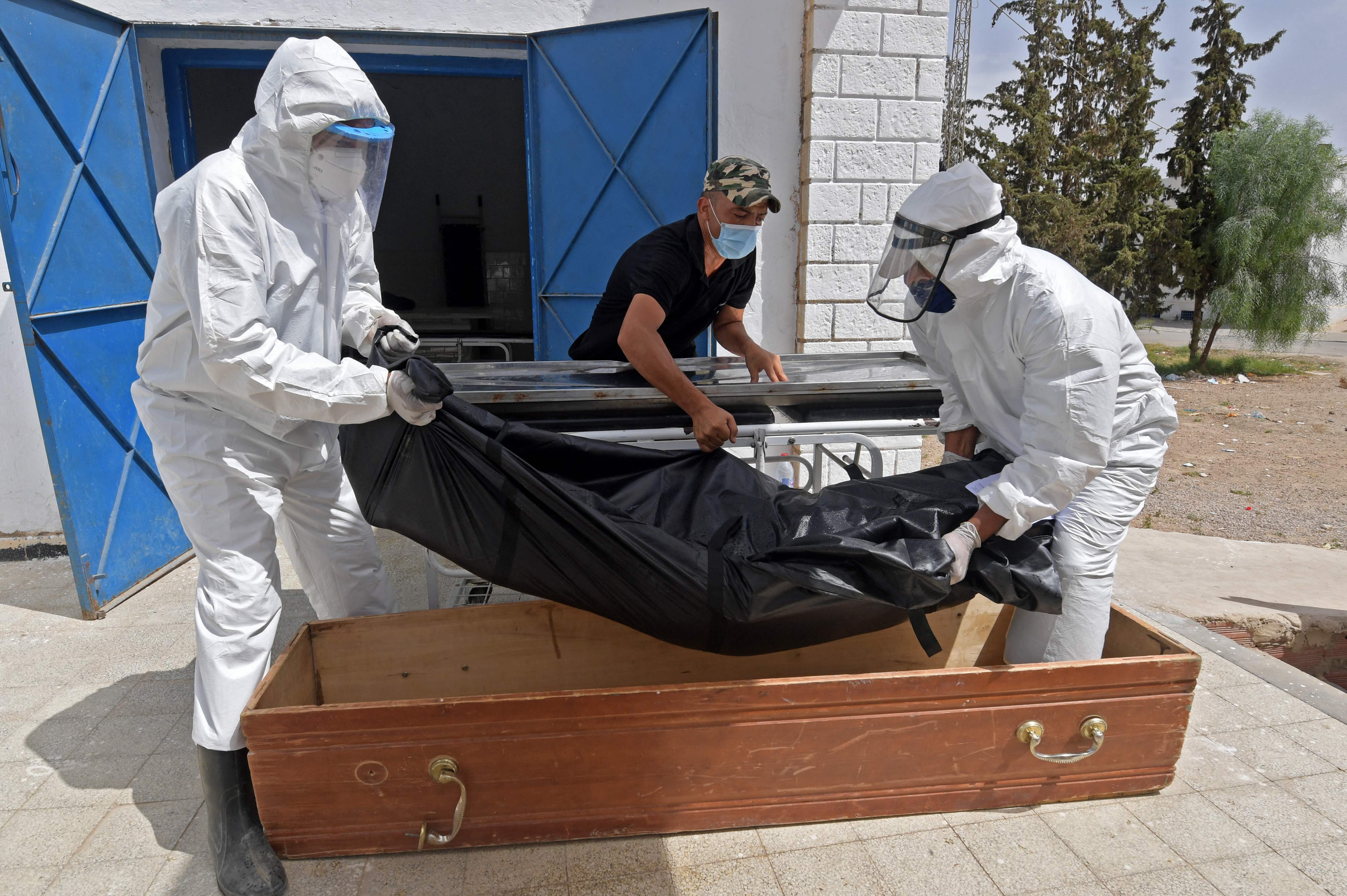 The body of a Covid-19 victim is placed into a casket at the Ibn al-Jazzar hospital in Kairouan, Tunisia