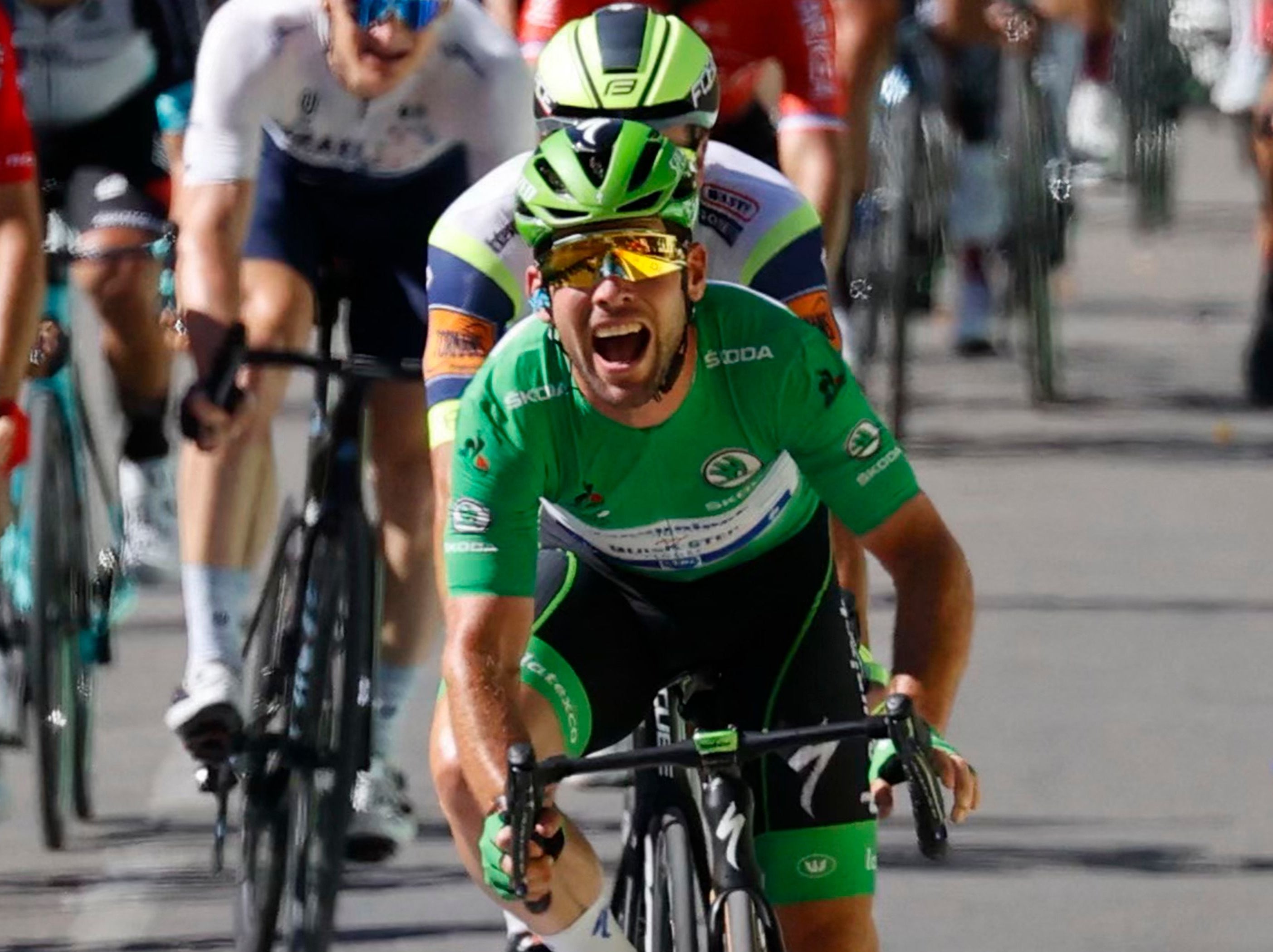 Mark Cavendish crosses the line as he wins stage 13