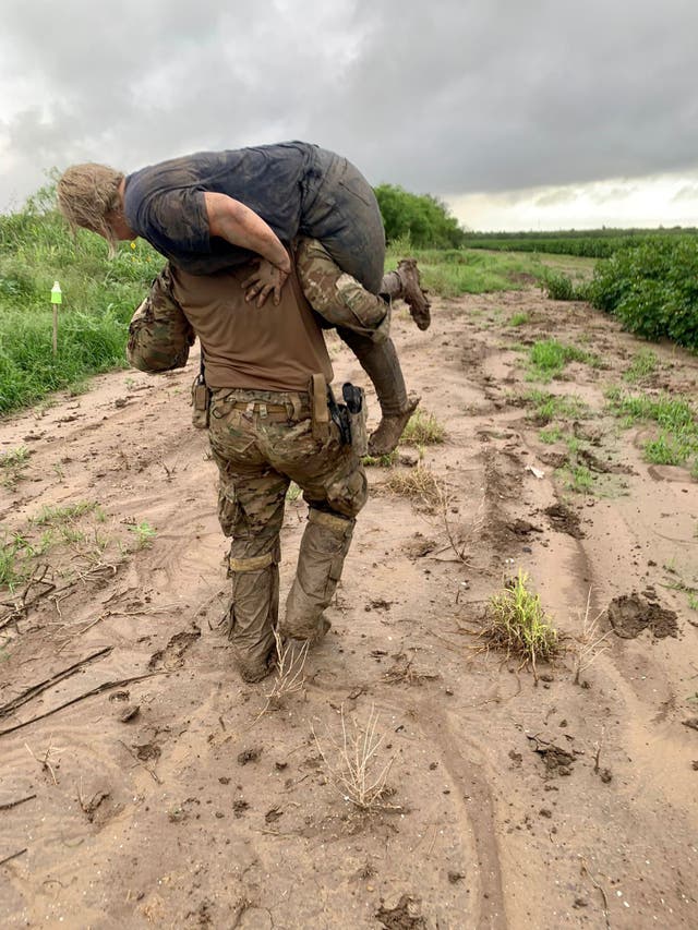 <p>A Border Patrol agent carries a migrant on his shoulders through rugged terrain near the US-Mexico border in the Rio Grande Valley of Texas.</p>