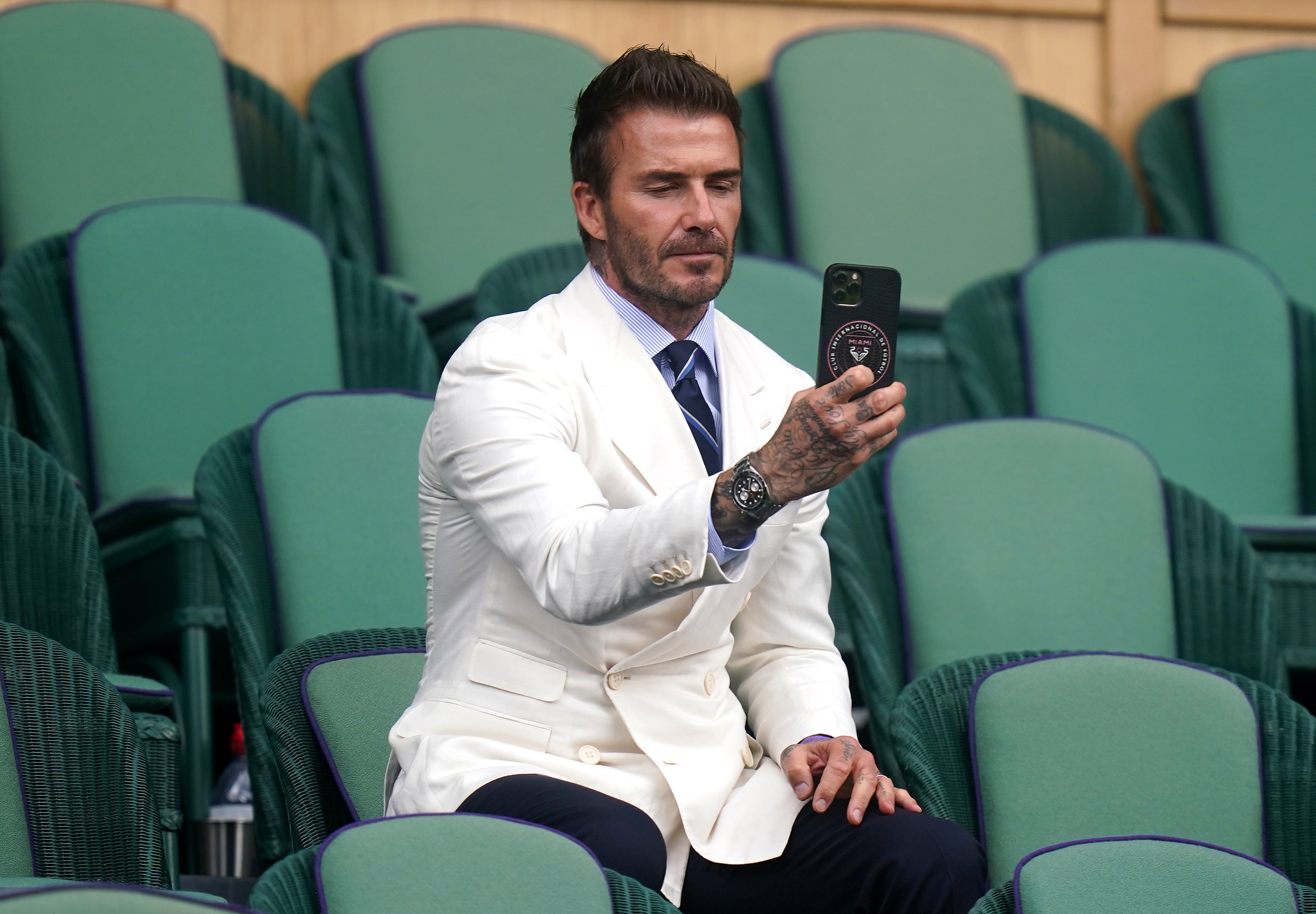 David Beckham takes a picture at Wimbledon