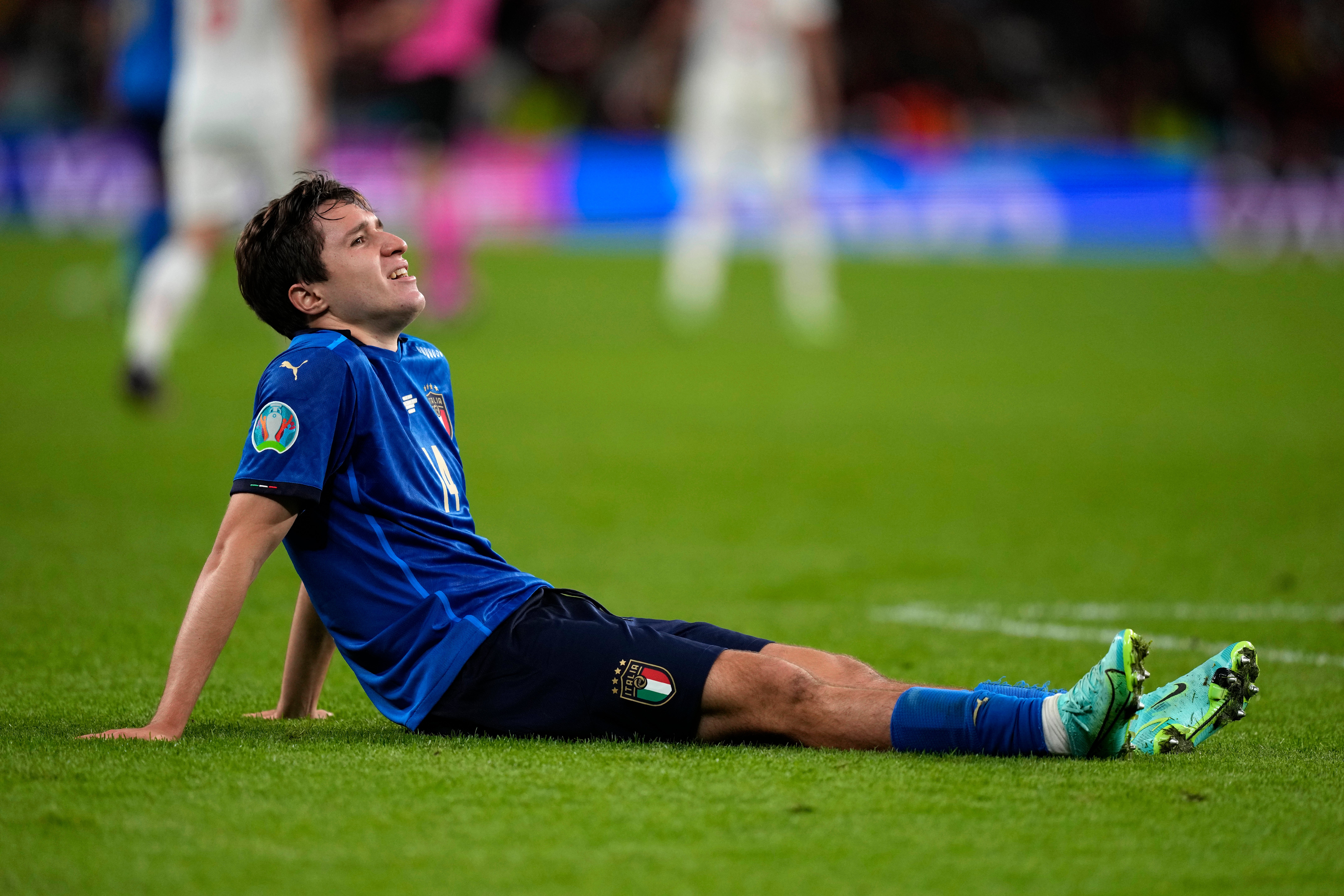 Italy's Federico Chiesa sits down on the pitch during the semi-final against Spain