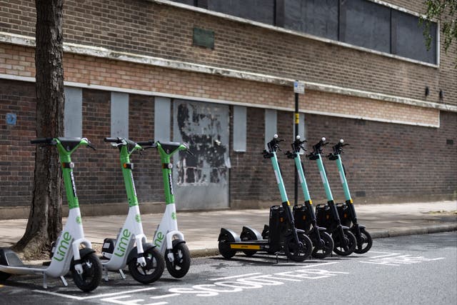 <p>A row of both Lime (L) and Tier (R) electric scooters are seen in a parking bay on July 05, 2021 in London, England.</p>