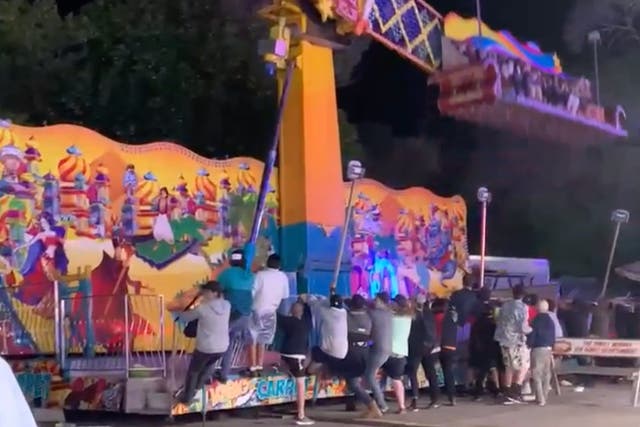 <p>Bystanders had to rush over to a carnival ride to stop it from toppling over, disturbing videos show. </p>