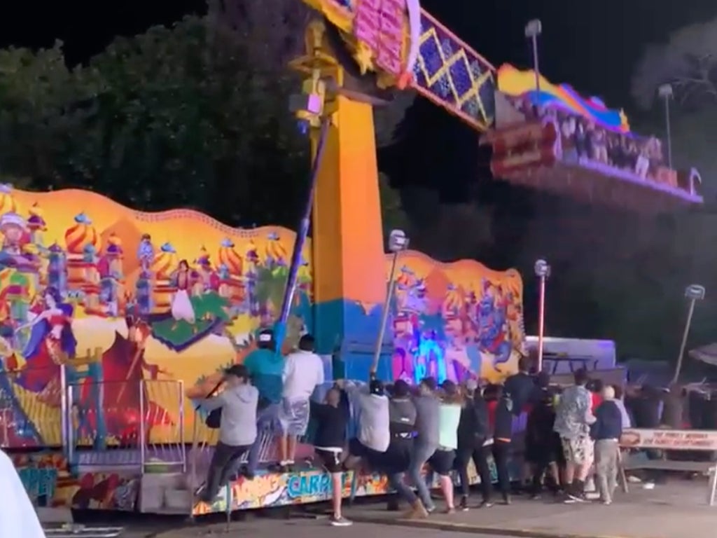 Footage captures terrifying moment bystanders rush to stop carnival ride from tipping over