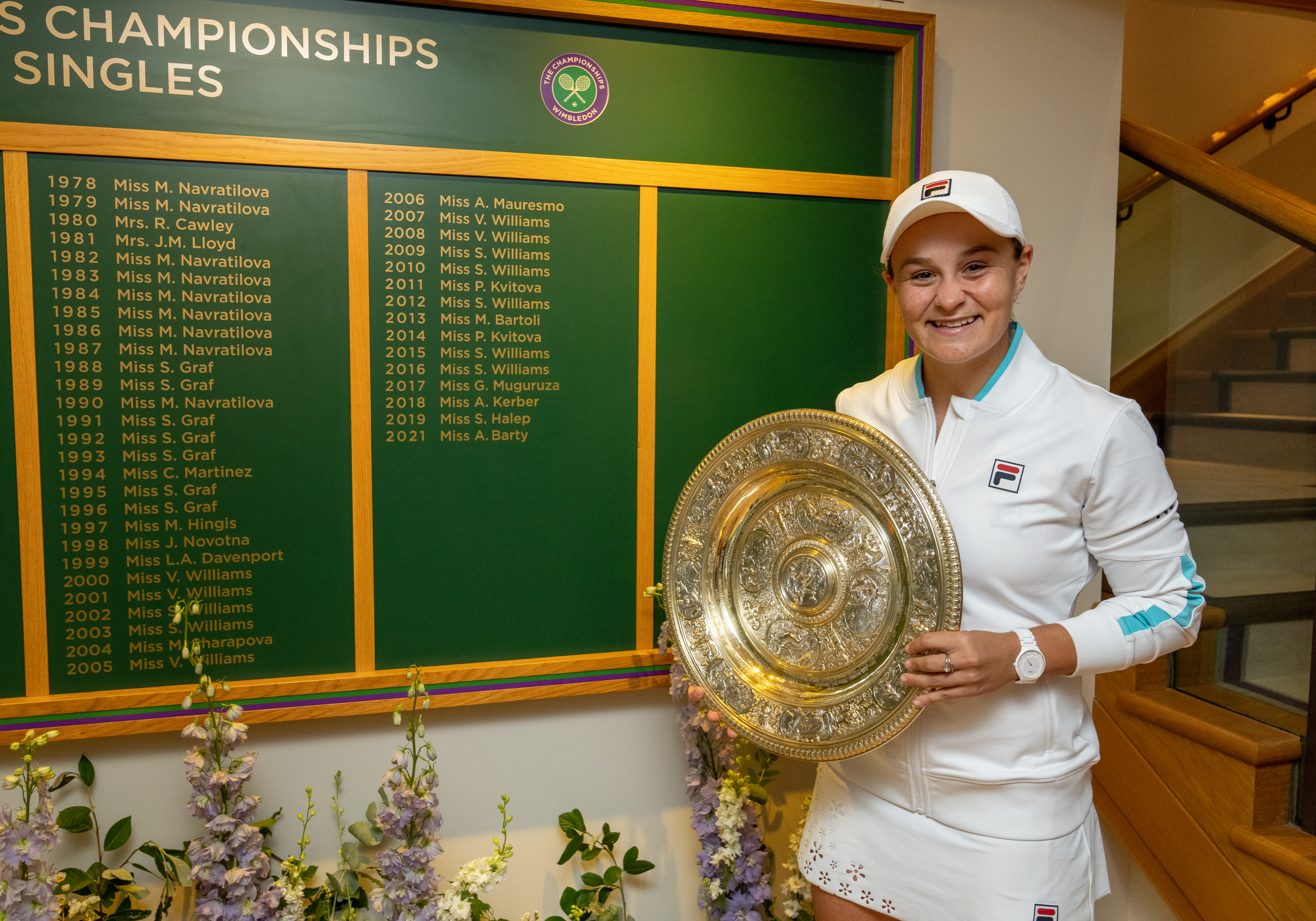 <p>Ashleigh Barty poses next to the honours board</p>