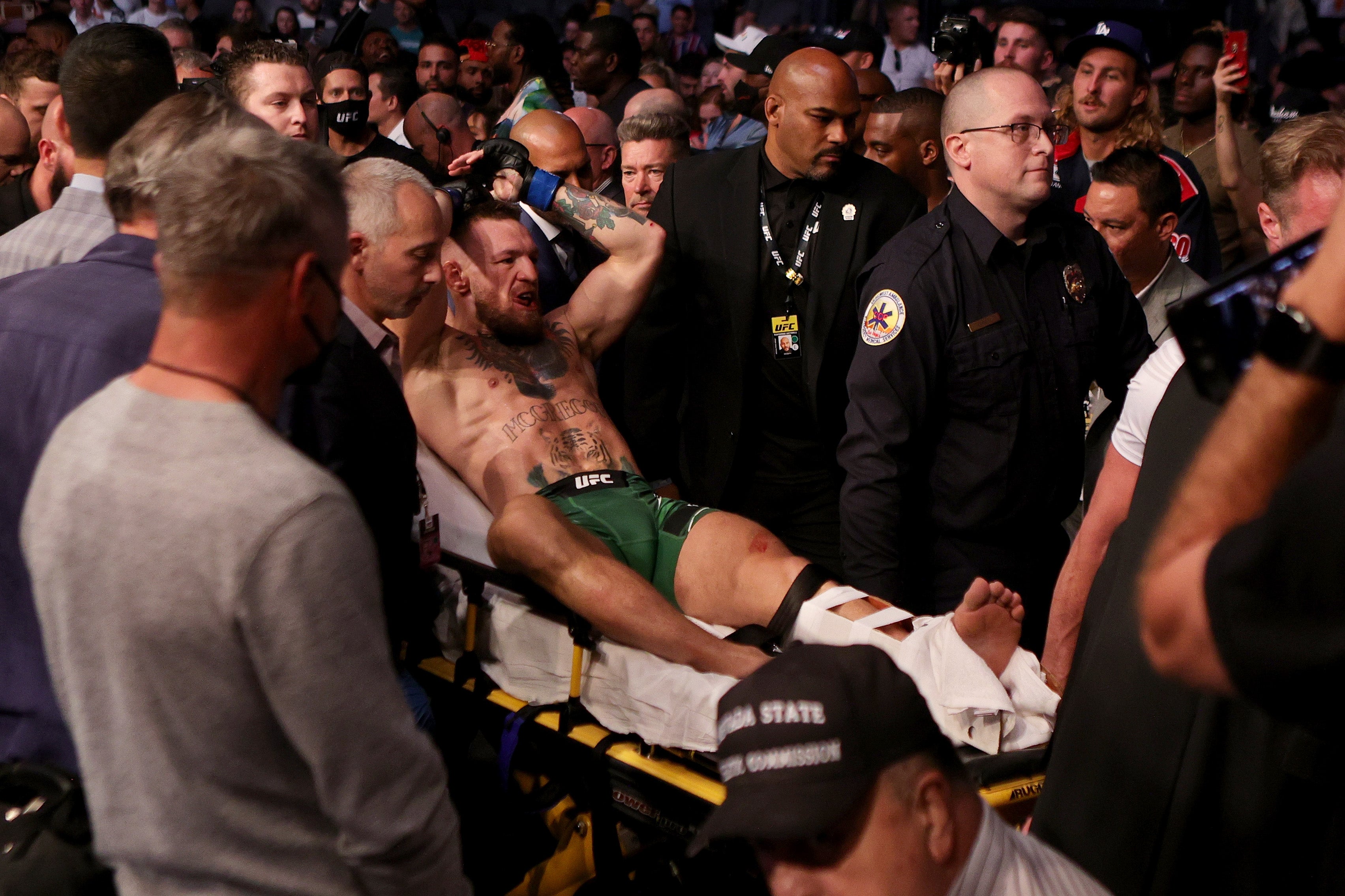 Conor McGregor of Ireland is carried out of the arena on a stretcher