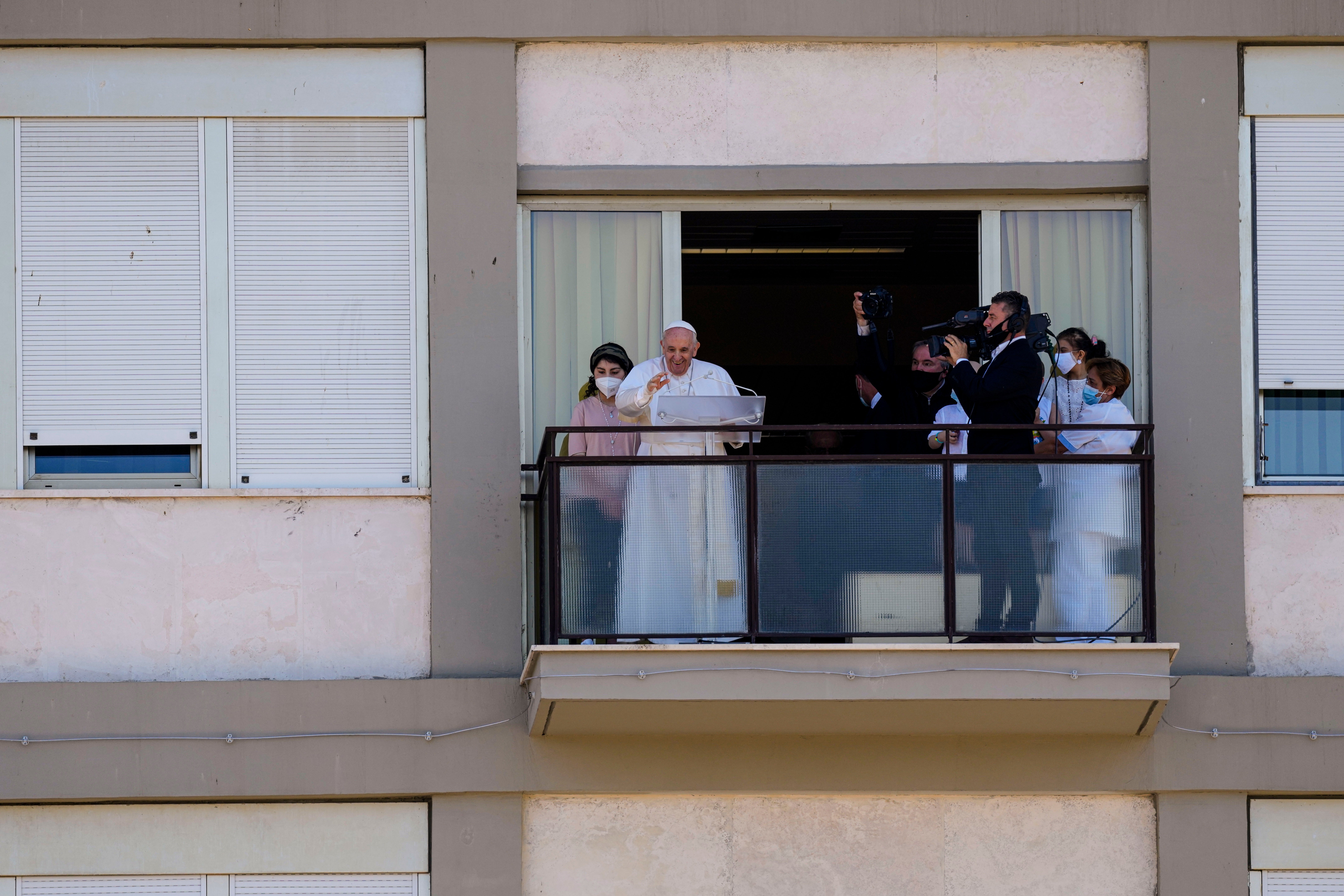 Pope Francis gives the traditional Sunday blessing and Angelus prayer from a hospital balcony