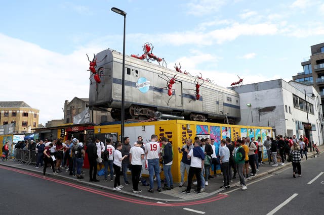 <p>England fans queue outside the Vinegar Yard in London before watching the Euro 2020 semi final match between England and Denmark</p>