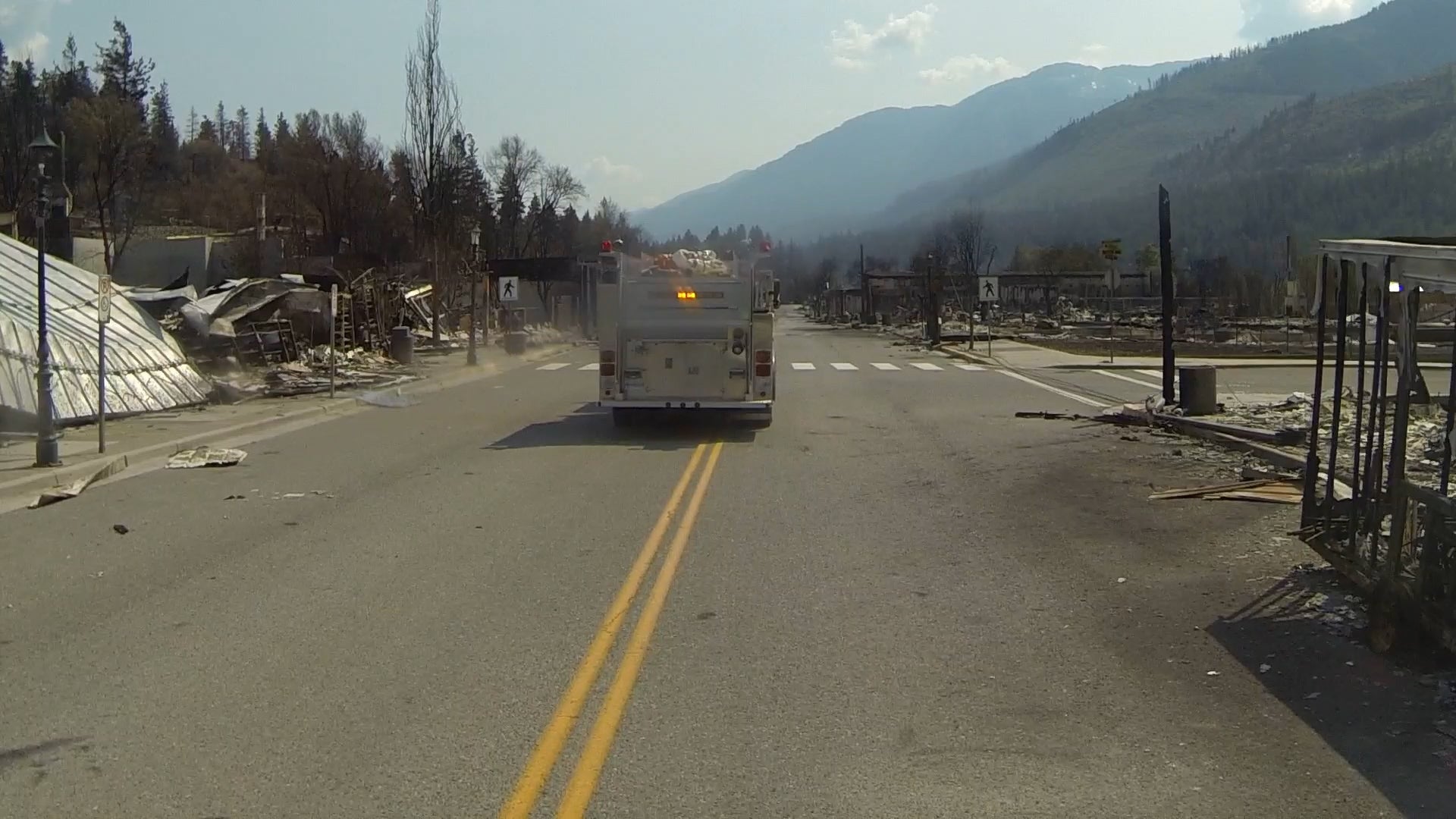 A bus tours Lytton with residents of the town that was devastated by fire.