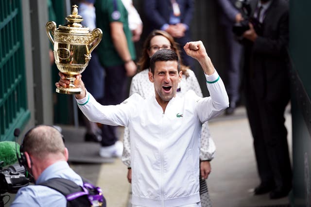<p>Novak Djokovic leaves Centre Court with the Wimbledon trophy</p>
