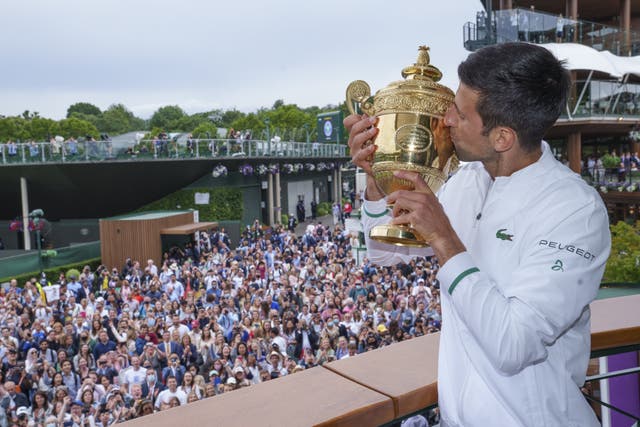 Novak Djokovic poses with the Wimbledon trophy