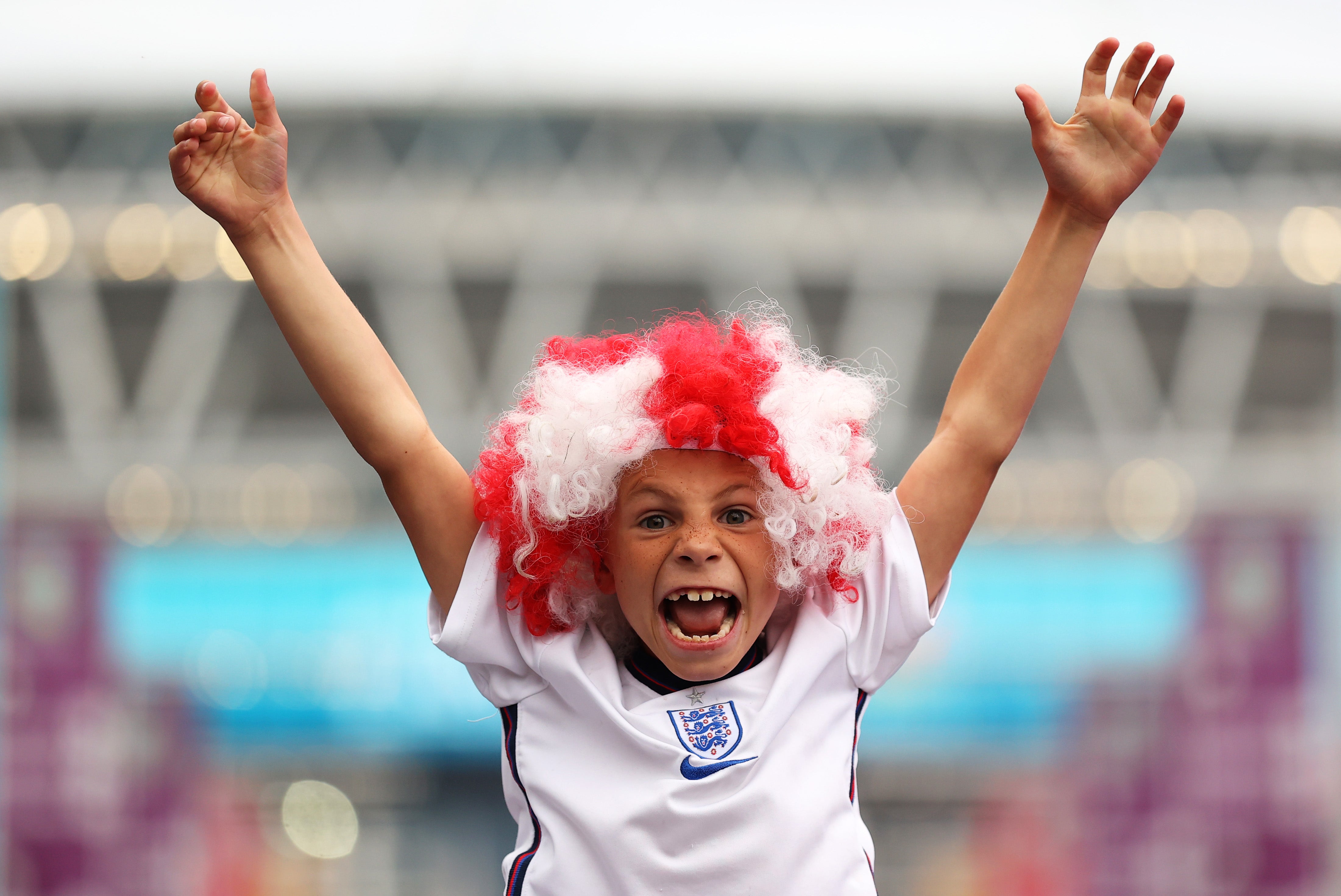 A fan of England wears a wig with England colours at Wembley on 11 July