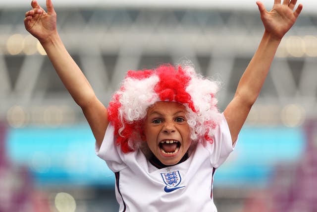 <p>: A fan of England wearing a wig shows their support along Wembley Way prior to the UEFA Euro 2020 Championship Final</p>