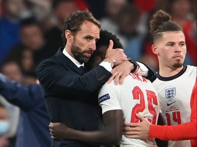 <p>England manager Gareth Southgate consoles a disconsolate Bukayo Saka at Wembley on Sunday. The Arsenal teenager was one of three England players to miss their penalties as Italy won the shootout 3-2</p>