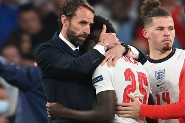 <p>England manager Gareth Southgate consoles a disconsolate Bukayo Saka at Wembley on Sunday. The Arsenal teenager was one of three England players to miss their penalties as Italy won the shootout 3-2</p>