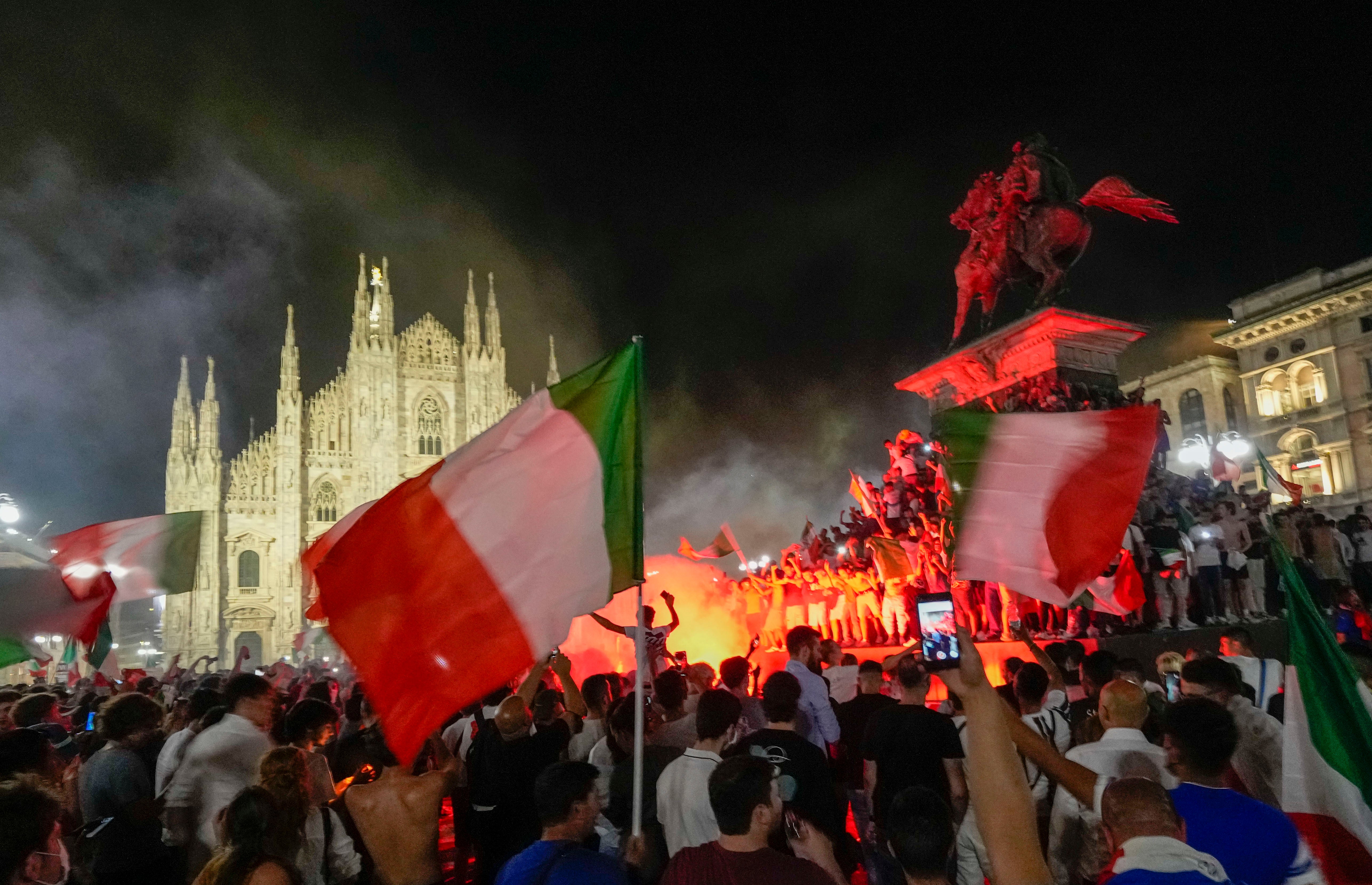 Fans celebrate in front of the Duomo cathedral in Milan