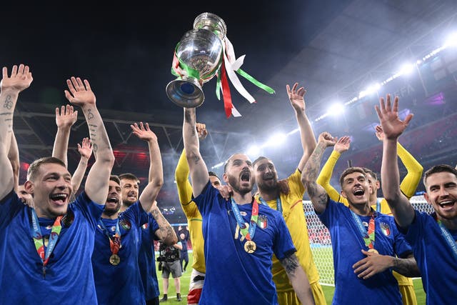 Italy’s Leonardo Bonucci throws the trophy in the air after winning Euro 2020