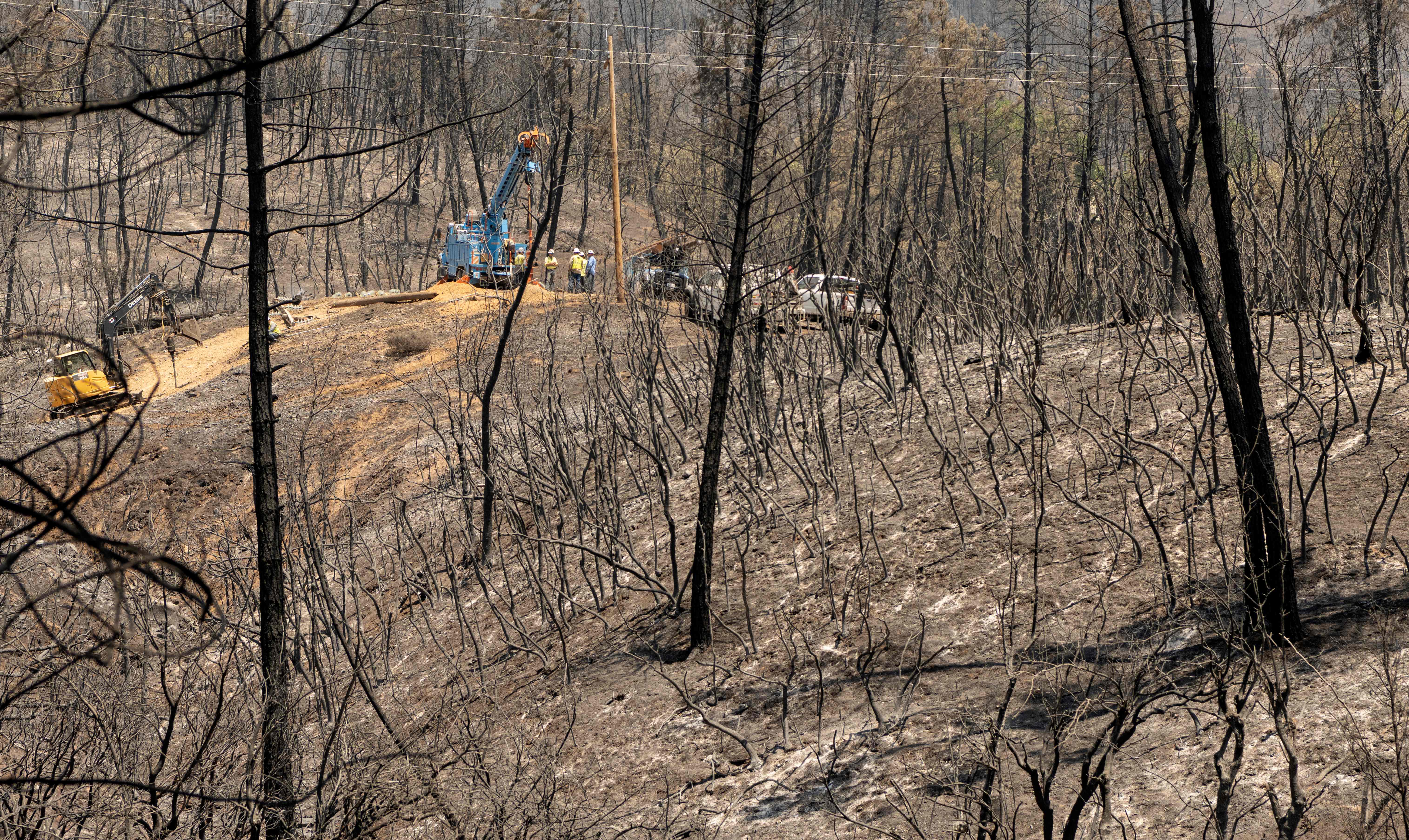 Crews work on a burned hillside during the Salt fire in the Gregory Creek area of Shasta County, California on 2 July 2021