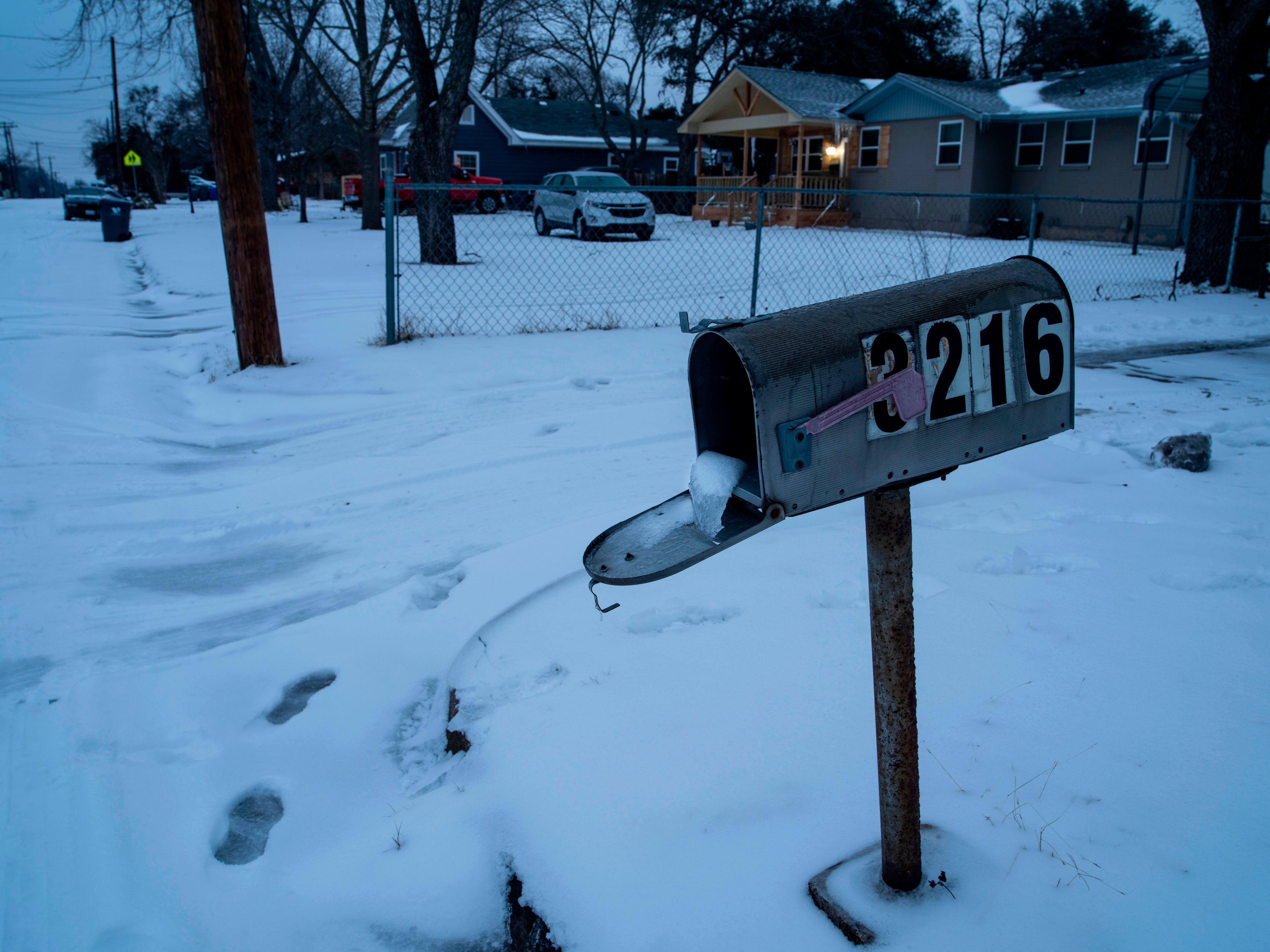 File: A mailbox is seen frozen in a snow-covered neighbourhood in Waco, Texas as severe winter weather conditions over the last few days has forced road closures and power outages over the state on 17 February 2021