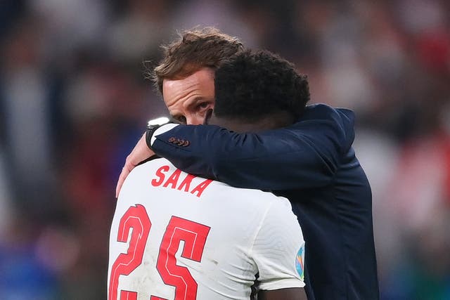 <p>Gareth Southgate consoles Bukayo Saka, who missed his penalty before suffering racist abuse</p>