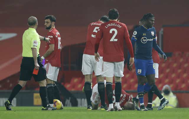 <p>Alex Jankewitz (right) leaves the game after being shown a red card against Manchester United (Phil Noble/PA)</p>