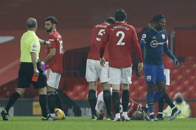 <p>Alex Jankewitz (right) leaves the game after being shown a red card against Manchester United (Phil Noble/PA)</p>