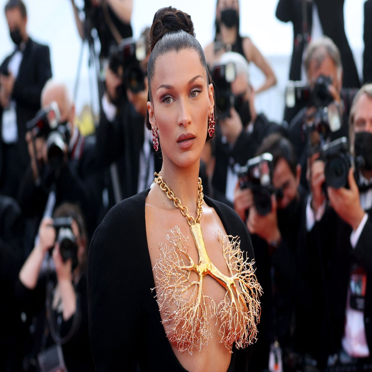bella hadid gold lung dress wears giant golden necklace with couture at Cannes red-carpet
