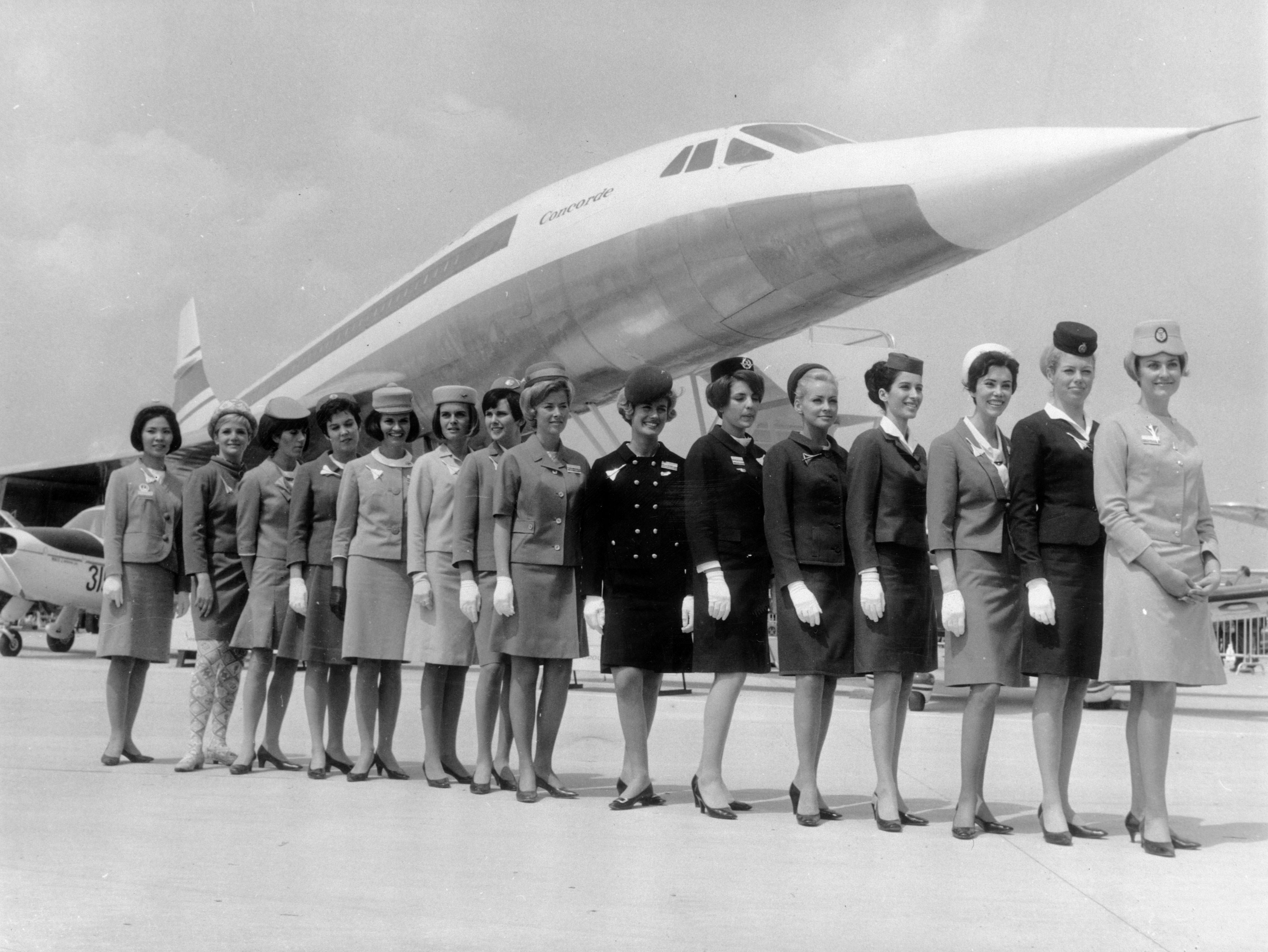 Cabin crew from several airlines in front of a scale model of the aircraft