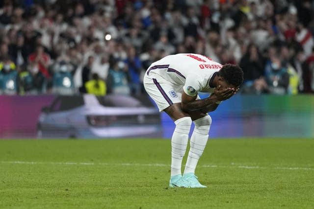 <p>Marcus Rashford is distraught after failing to score in the penalty shootout </p>