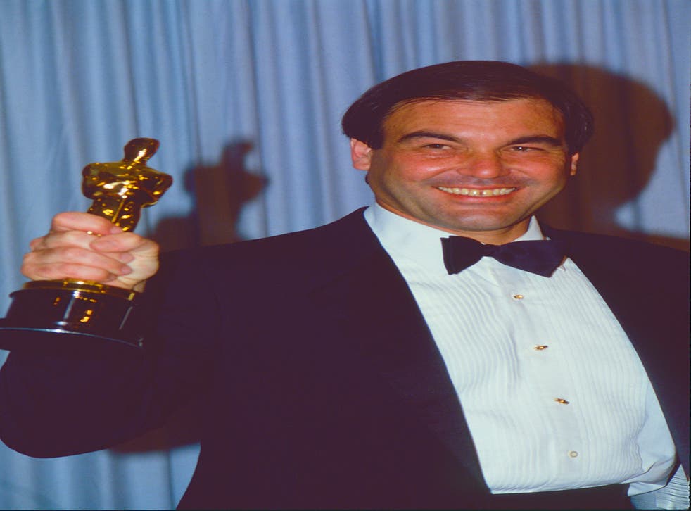 <p>Oliver Stone with his Best Director Oscar for ‘Platoon’ in 1987</p>