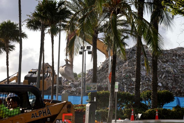 <p>Excavators dig through the pile of debris from the collapsed 12-story Champlain Towers South condo building on July 11, 2021 in Surfside, Florida.</p>