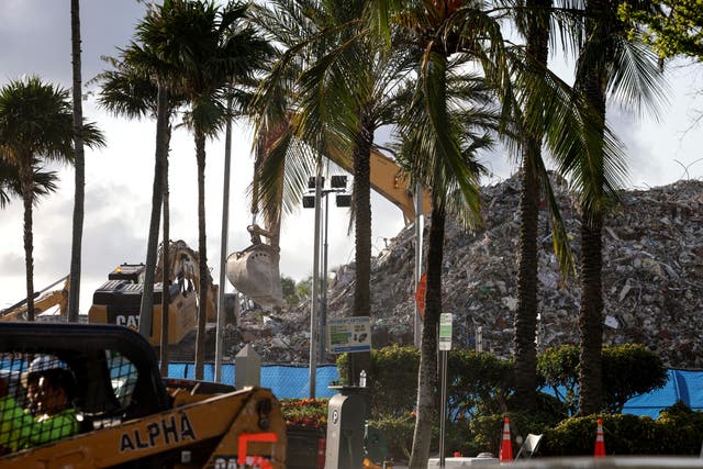 <p>Excavators dig through the pile of debris from the collapsed 12-story Champlain Towers South condo building on July 11, 2021 in Surfside, Florida.</p>